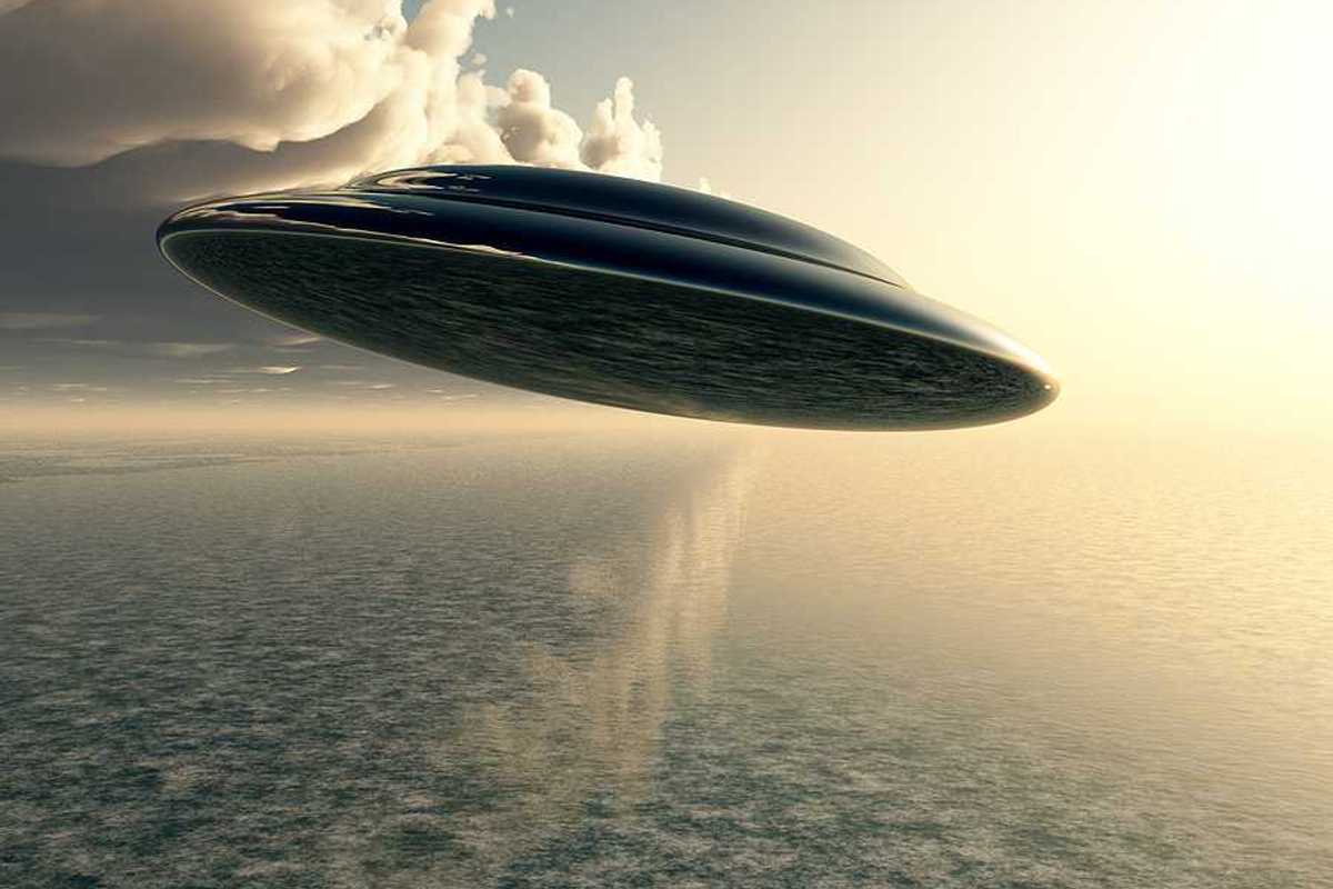 An illustration of a saucer-like space ship flying against a cloudy sky