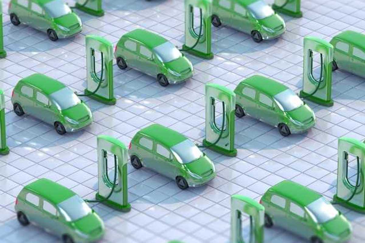 An illustration showing green electric vehicles hooked up to EV charging ports
