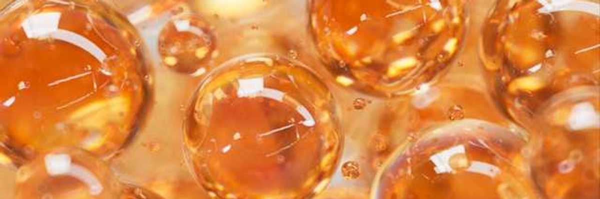 An illustration with orange colored liquid balls that look like bubbles