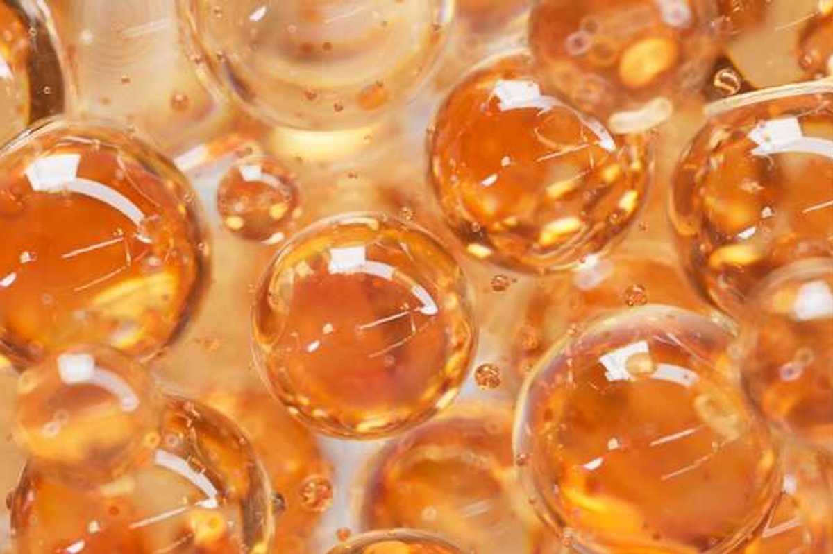 An illustration with orange colored liquid balls that look like bubbles