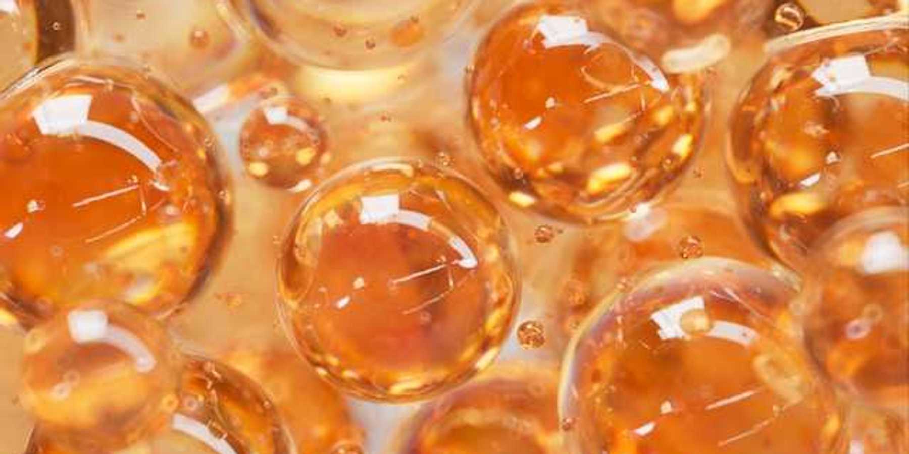 An illustration with orange colored liquid balls that look like bubbles