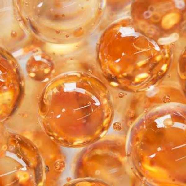 An illustration with orange colored liquid balls that look like bubbles