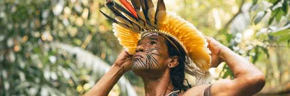 An indigenous Amazon tribe member wearing ceremonial garb