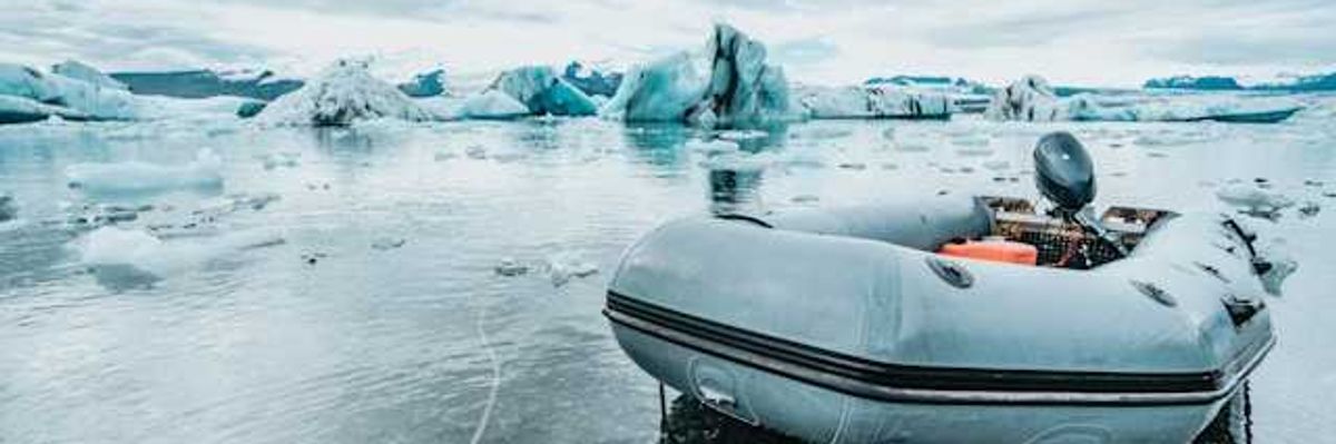 An inflatable boat pulled up to an icy shore