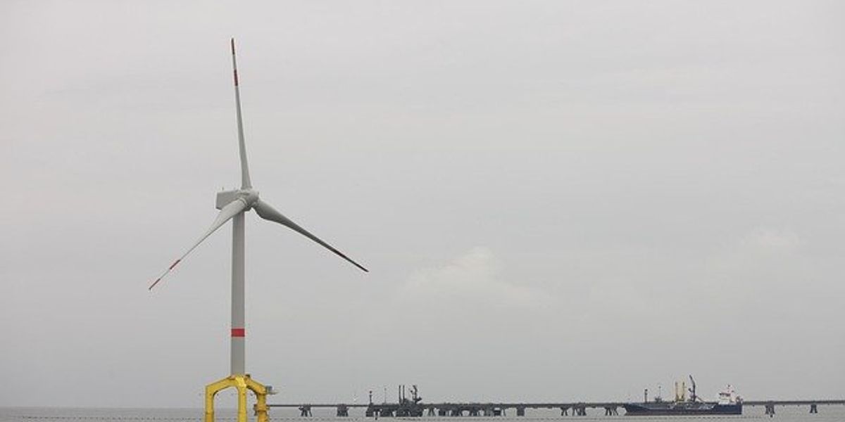 An offshore wind turbine on a cloudy day.