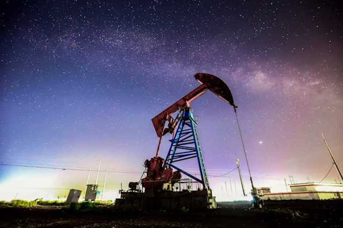 An oil pump jack against a starry sky