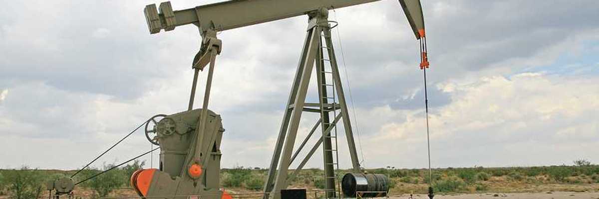 An oil pump jack in a dry field