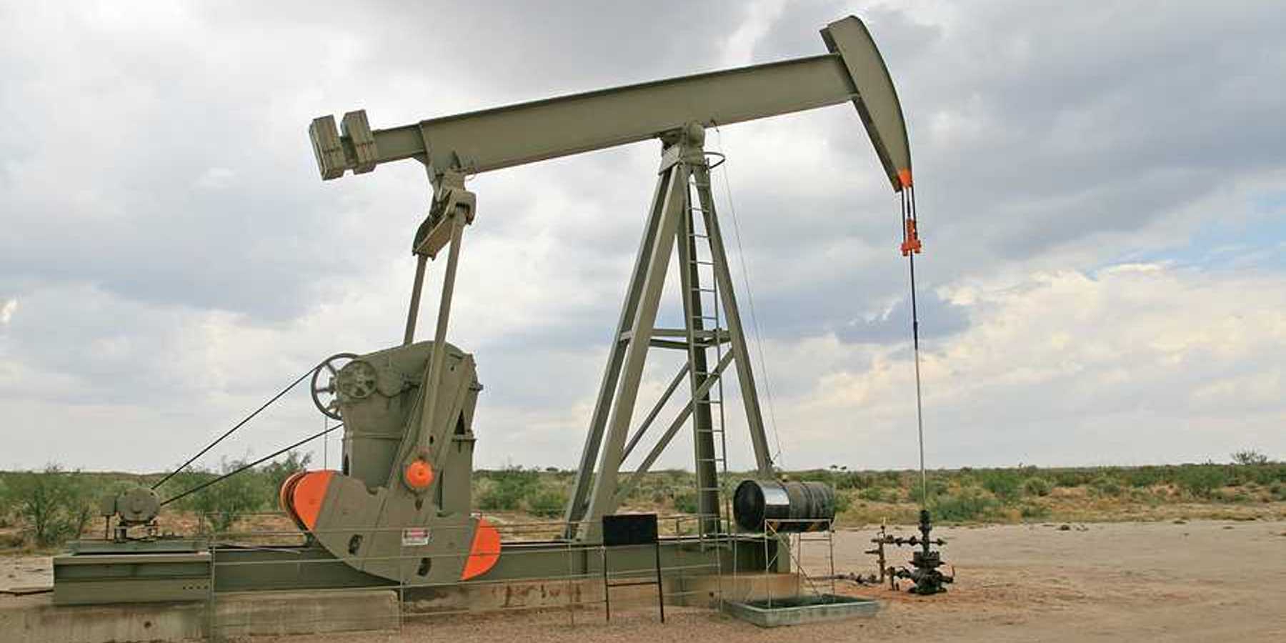 An oil pump jack in a dry field