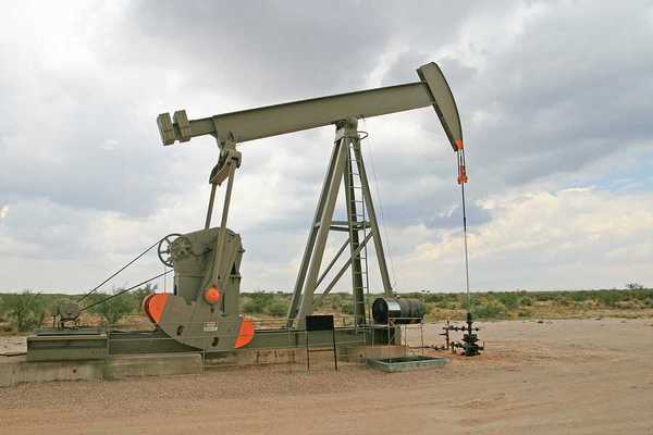 An oil pump jack in a dry field