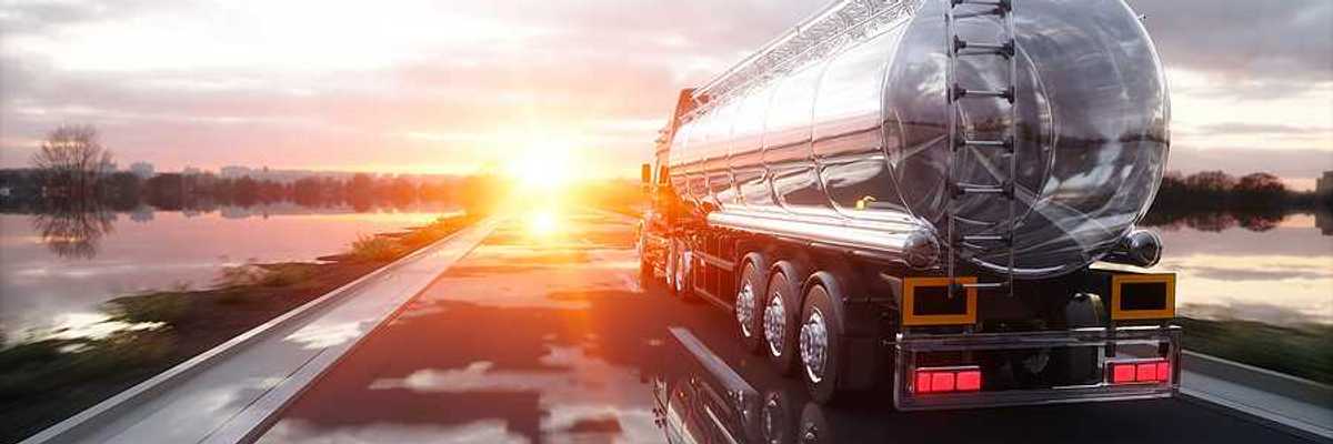 An oil tank truck driving down a highway