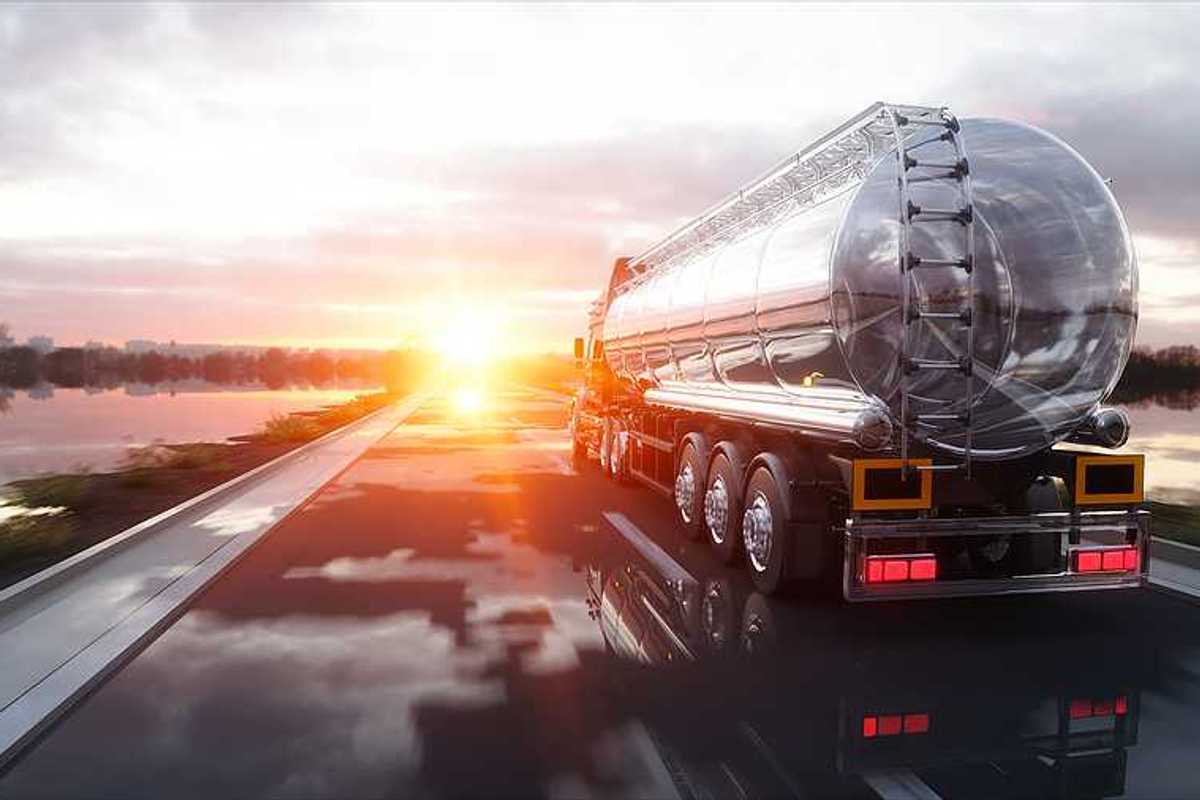 An oil tank truck driving down a highway