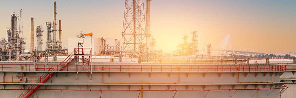 An oil tank with the sunset in the background
