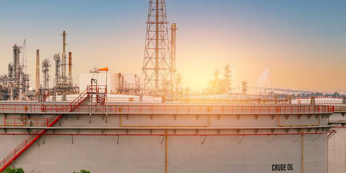 An oil tank with the sunset in the background