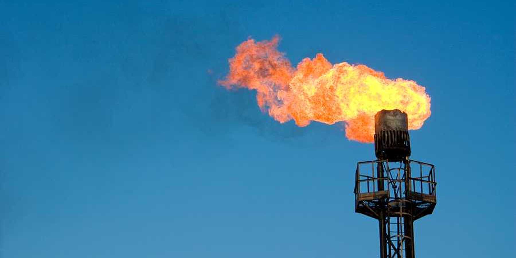 An oil tower flaring gas into the sky