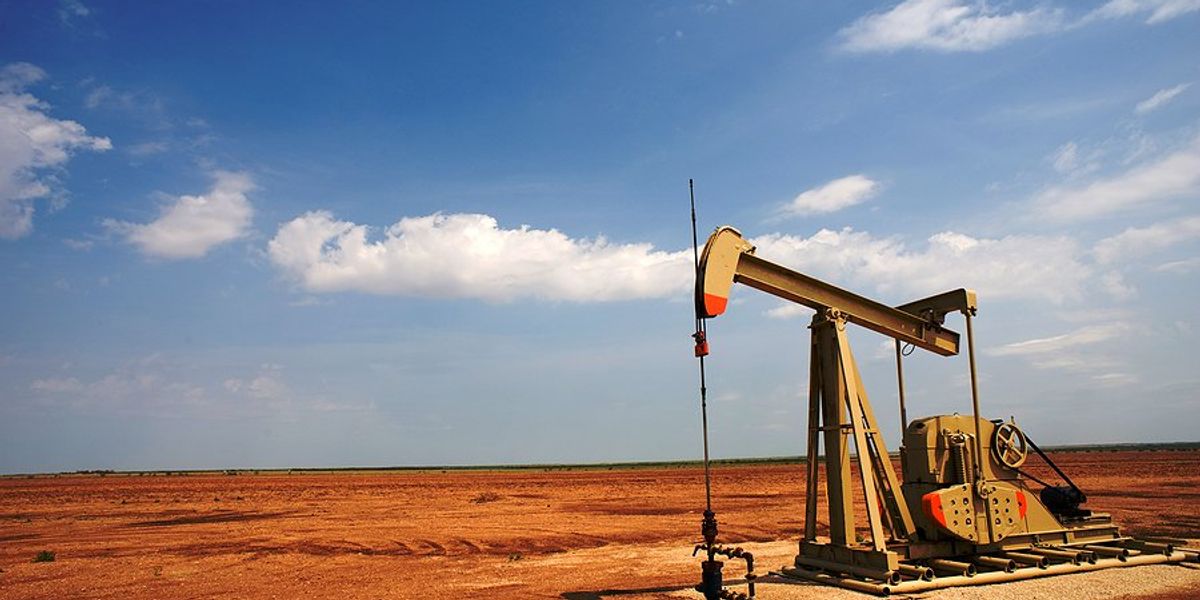 An old oil pump jack in a dry field