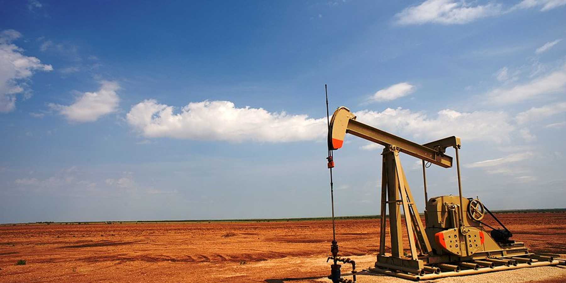 An old oil pump jack in a dry field