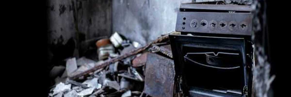 An old oven sitting in the middle of a destroyed building