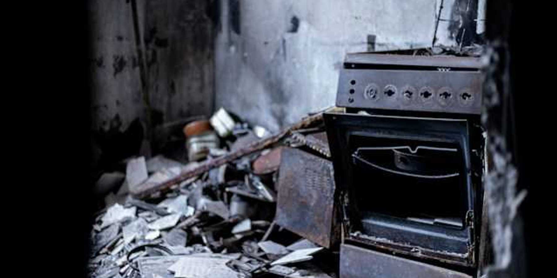 An old oven sitting in the middle of a destroyed building