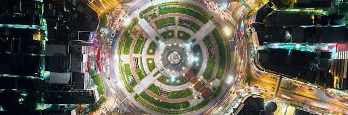 An overhead view of a city roundabout with a park in the middle