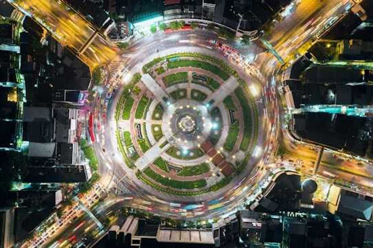 An overhead view of a city roundabout with a park in the middle