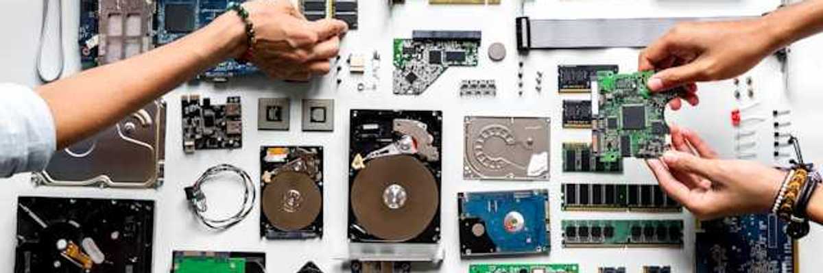 An overhead view of a table covered with electronic waste