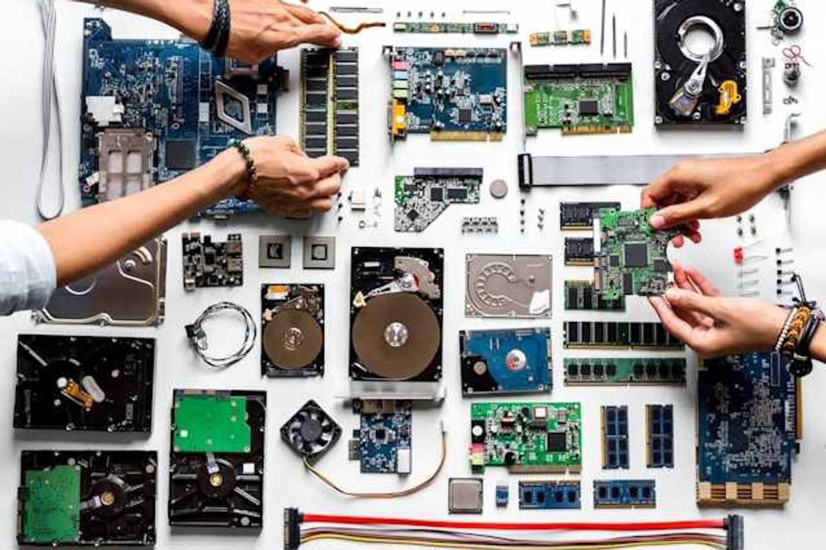 An overhead view of a table covered with electronic waste