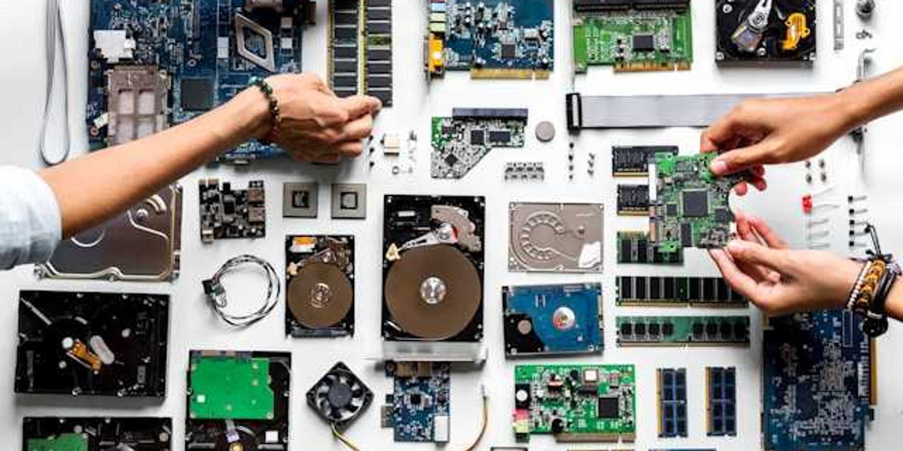 An overhead view of a table covered with electronic waste
