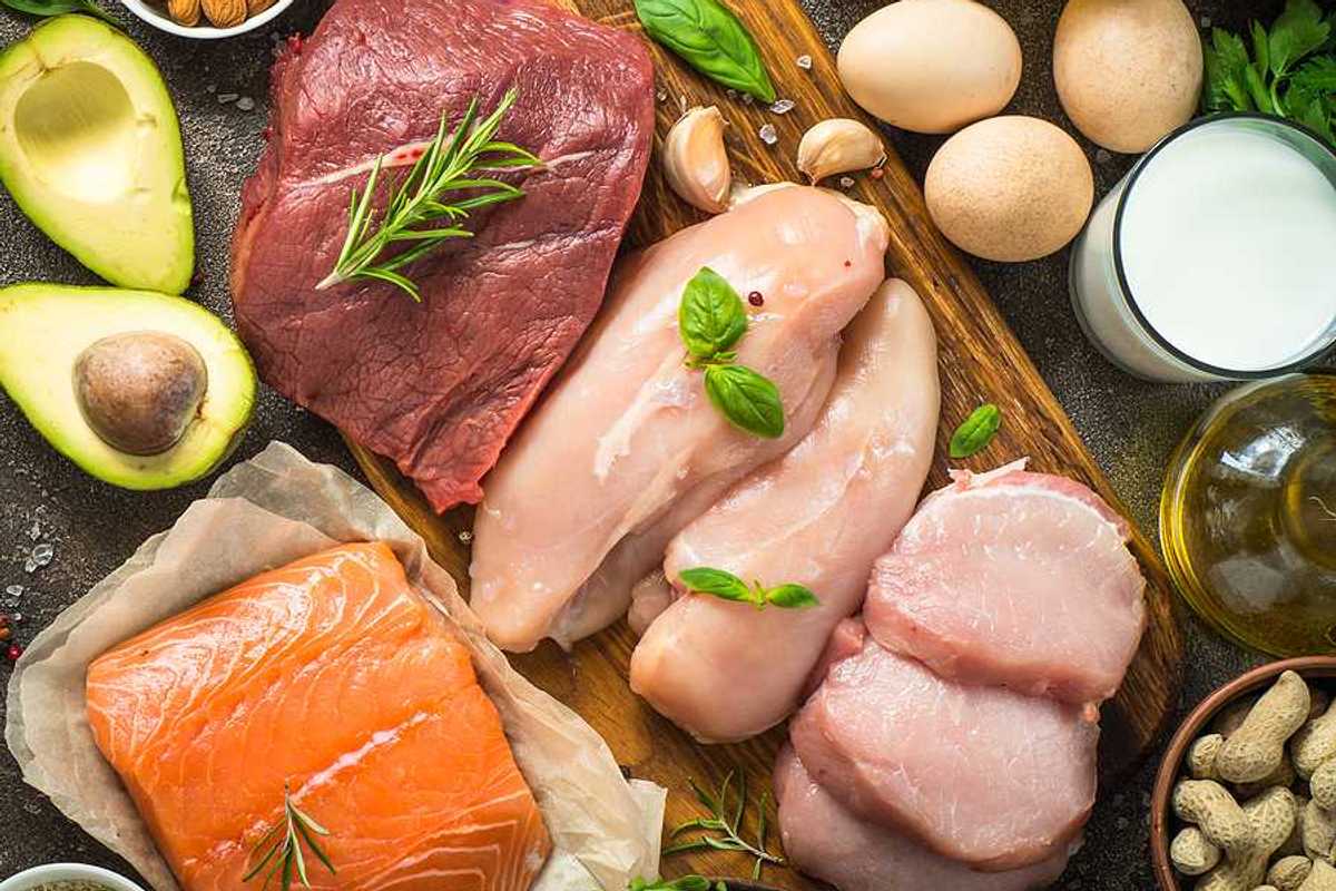An overhead view of a table filled with meats, fish, poultry, and eggs