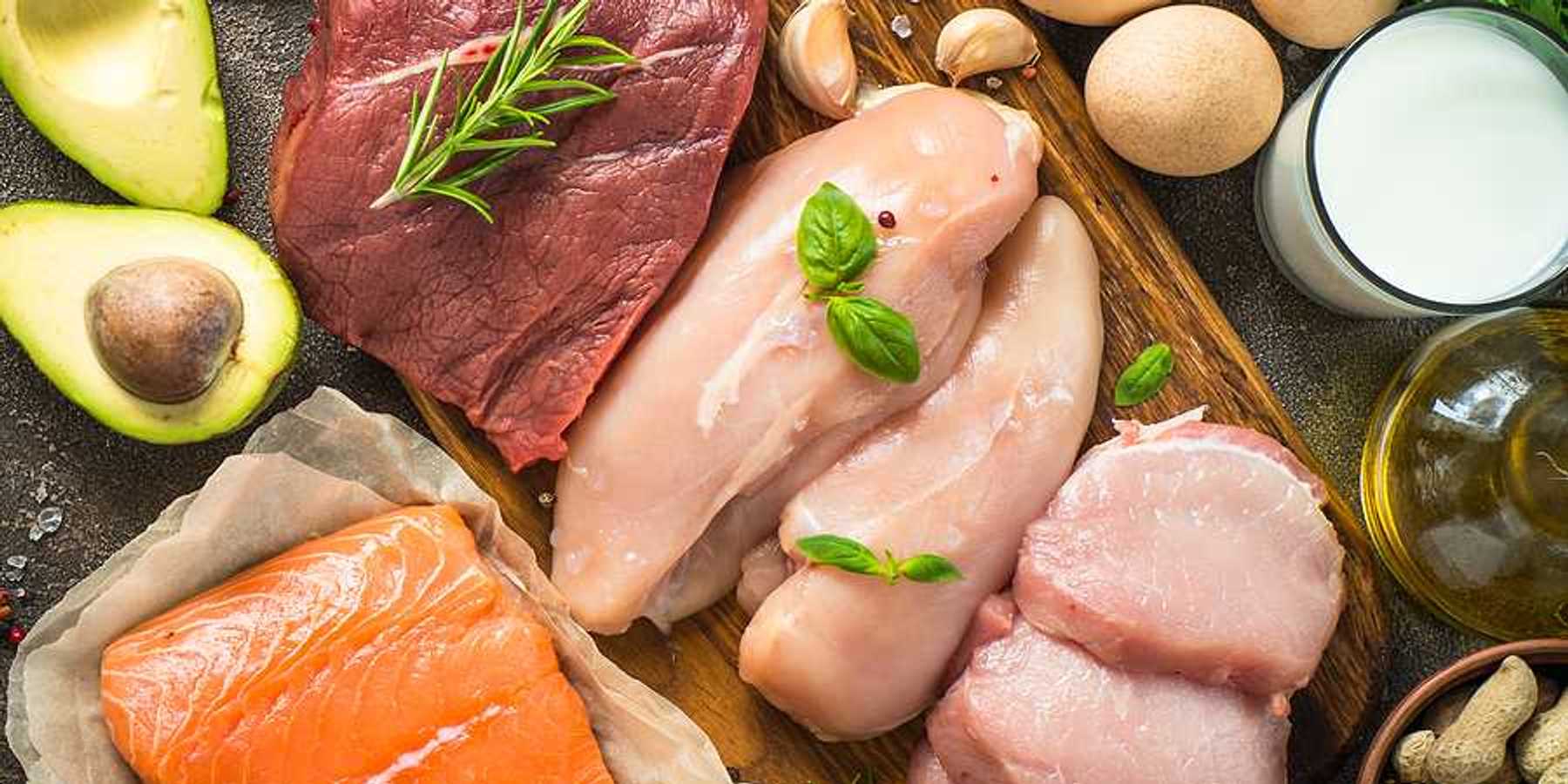 An overhead view of a table filled with meats, fish, poultry, and eggs