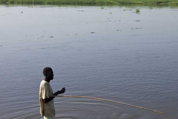 An unidentified man fishes in the White Nile river of South Sudan.