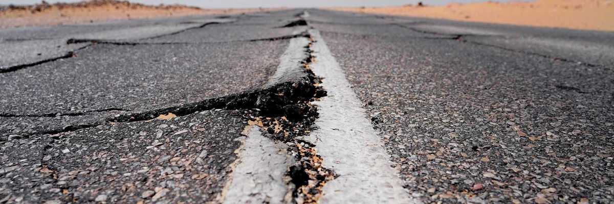 Asphalt roadway showing buckling from extreme heat
