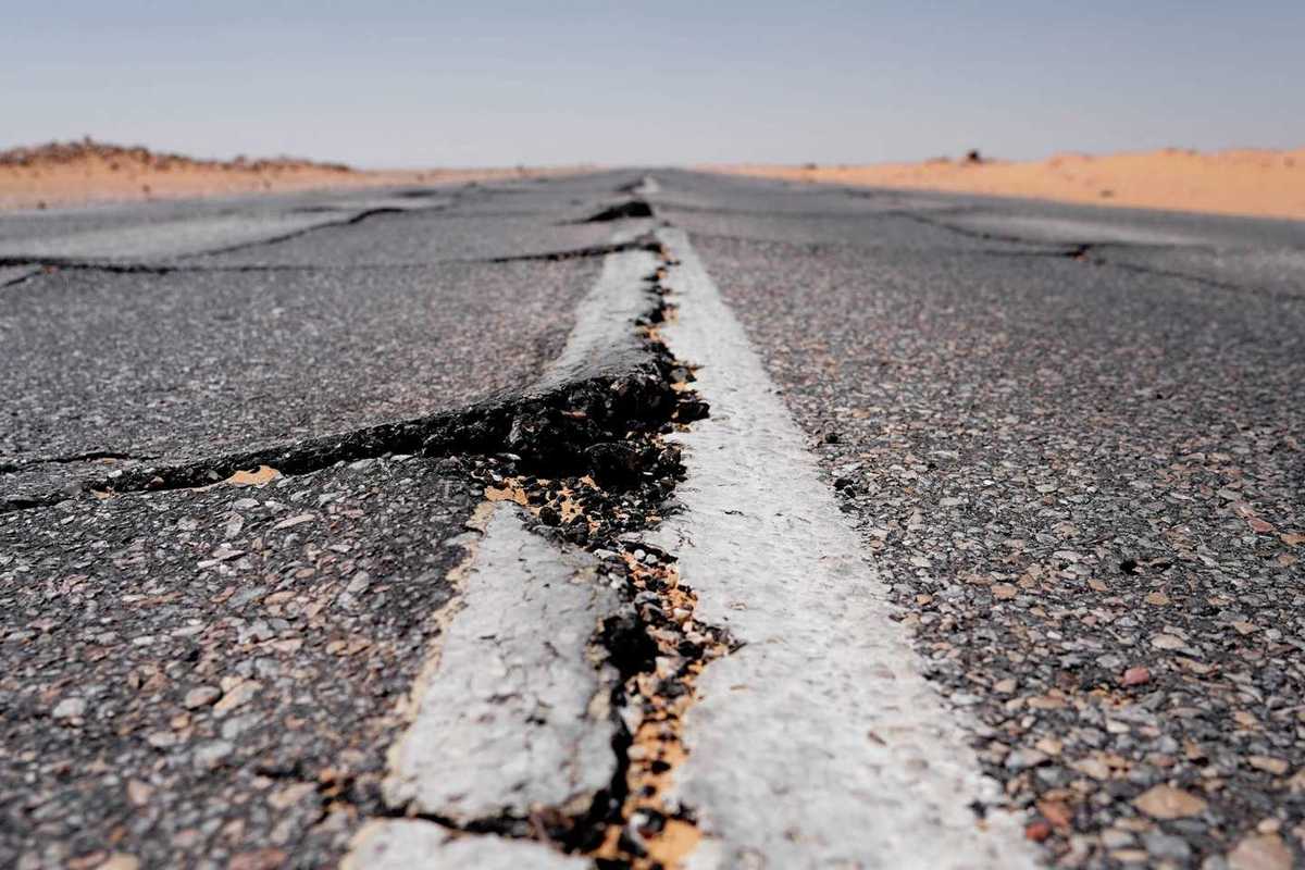 Asphalt roadway showing buckling from extreme heat