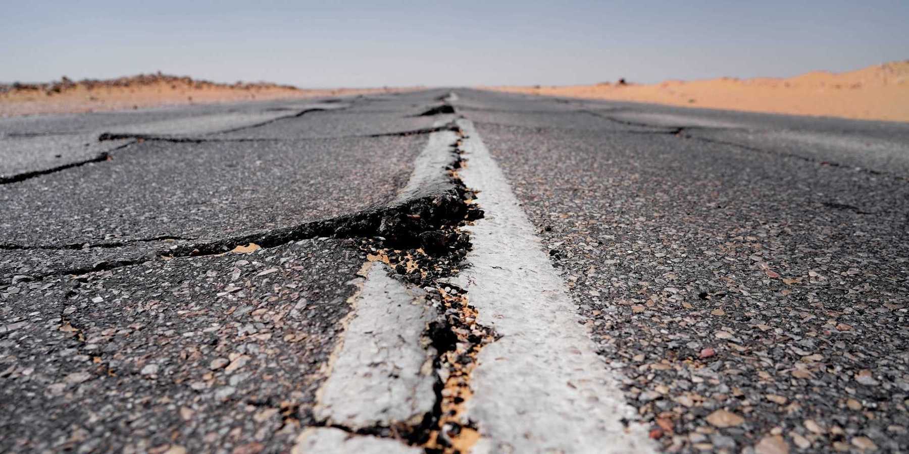 Asphalt roadway showing buckling from extreme heat