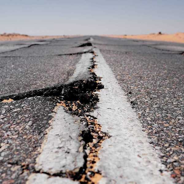 Asphalt roadway showing buckling from extreme heat