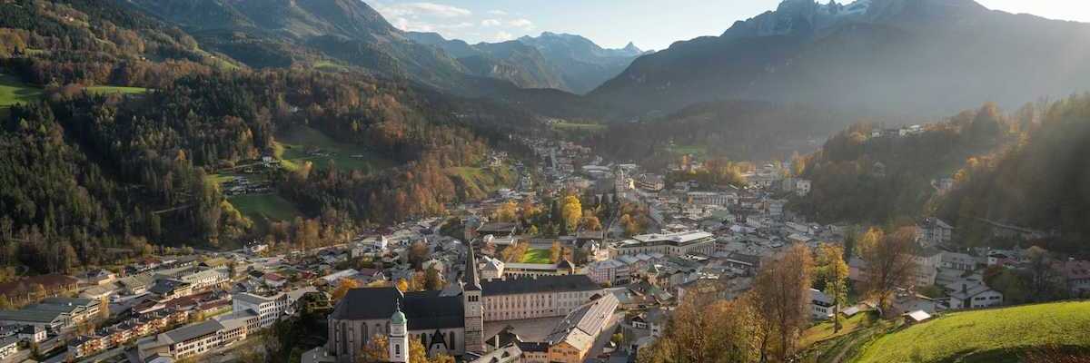 Bavarian town in an alpine valley beneath snow-capped peaks