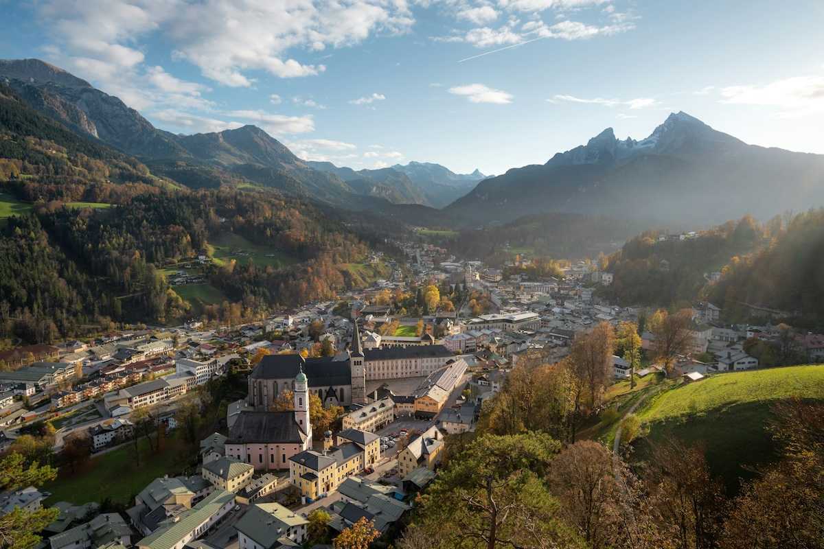 Bavarian town in an alpine valley beneath snow-capped peaks