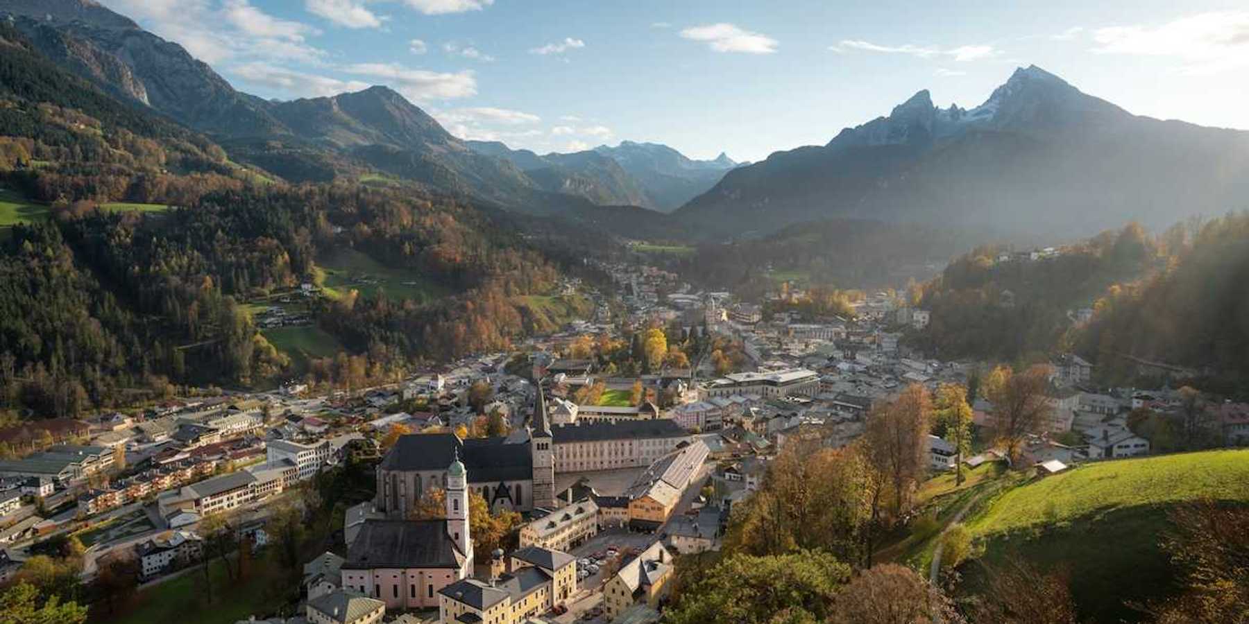 Bavarian town in an alpine valley beneath snow-capped peaks