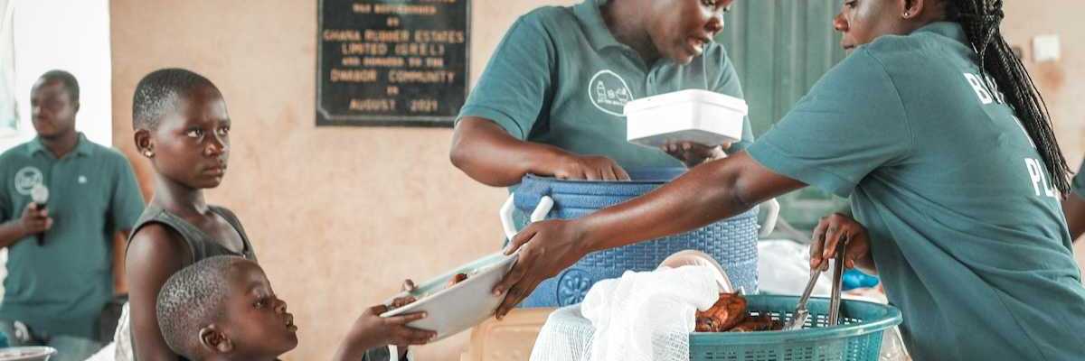 Black children being served at a food kitchen.