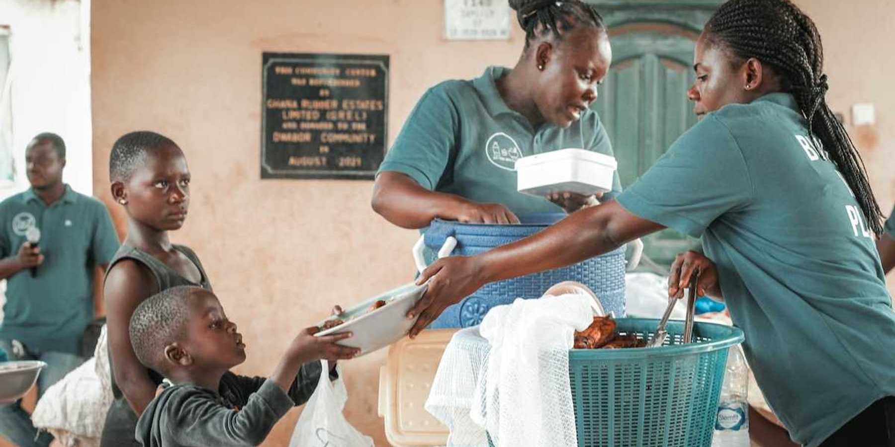 Black children being served at a food kitchen.