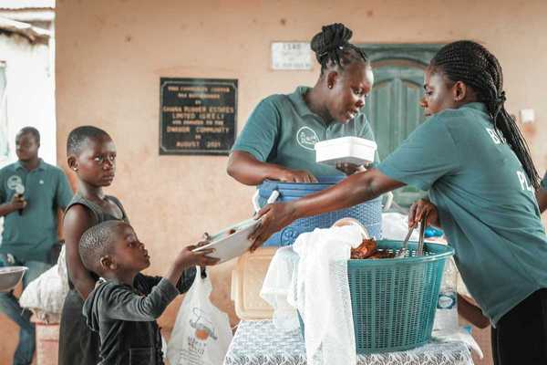 Black children being served at a food kitchen.