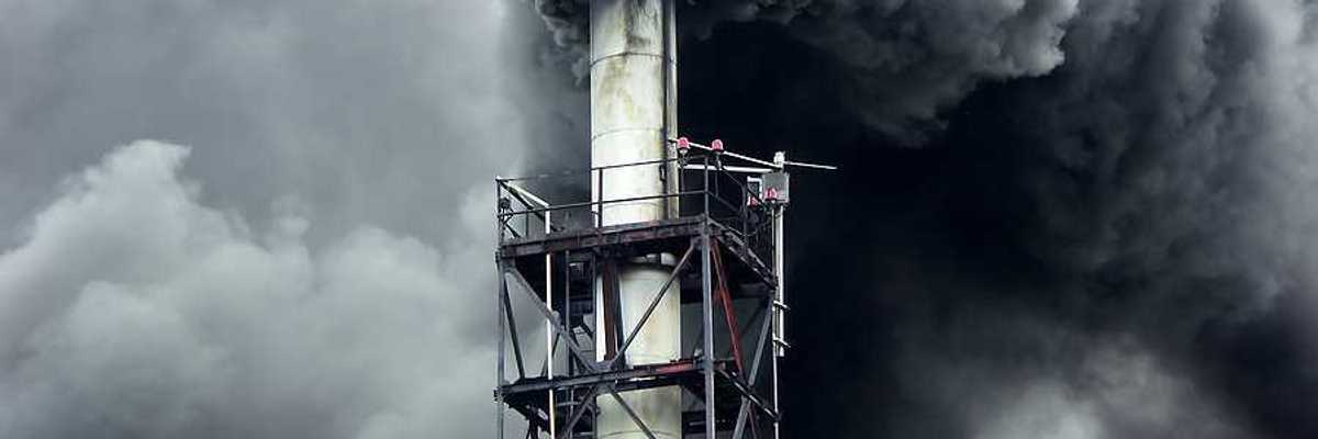 Black smoke billowing out of a smokestack