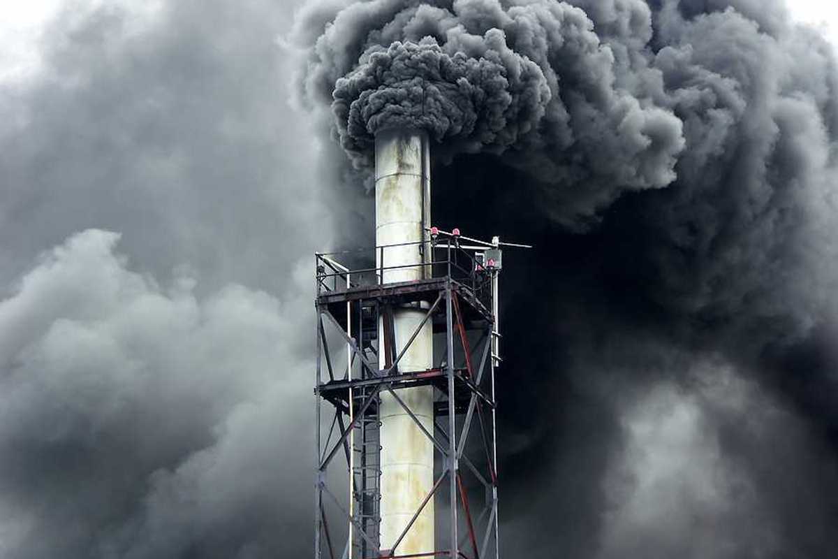 Black smoke billowing out of a smokestack