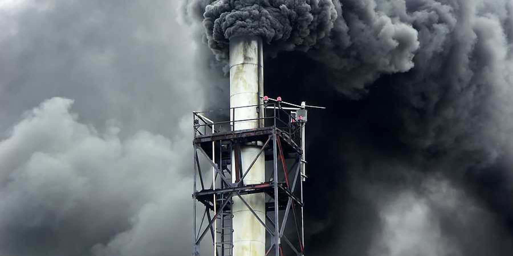 Black smoke billowing out of a smokestack