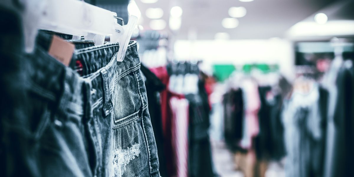 blue denim jeans on a rack in a clothing store.