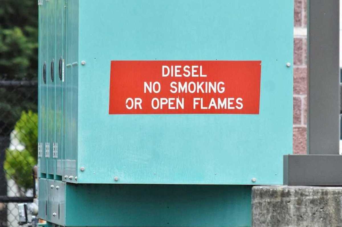 Blue-green diesel generator with signage reading: "DIESEL NO SMOKING OR OPEN FLAMES"