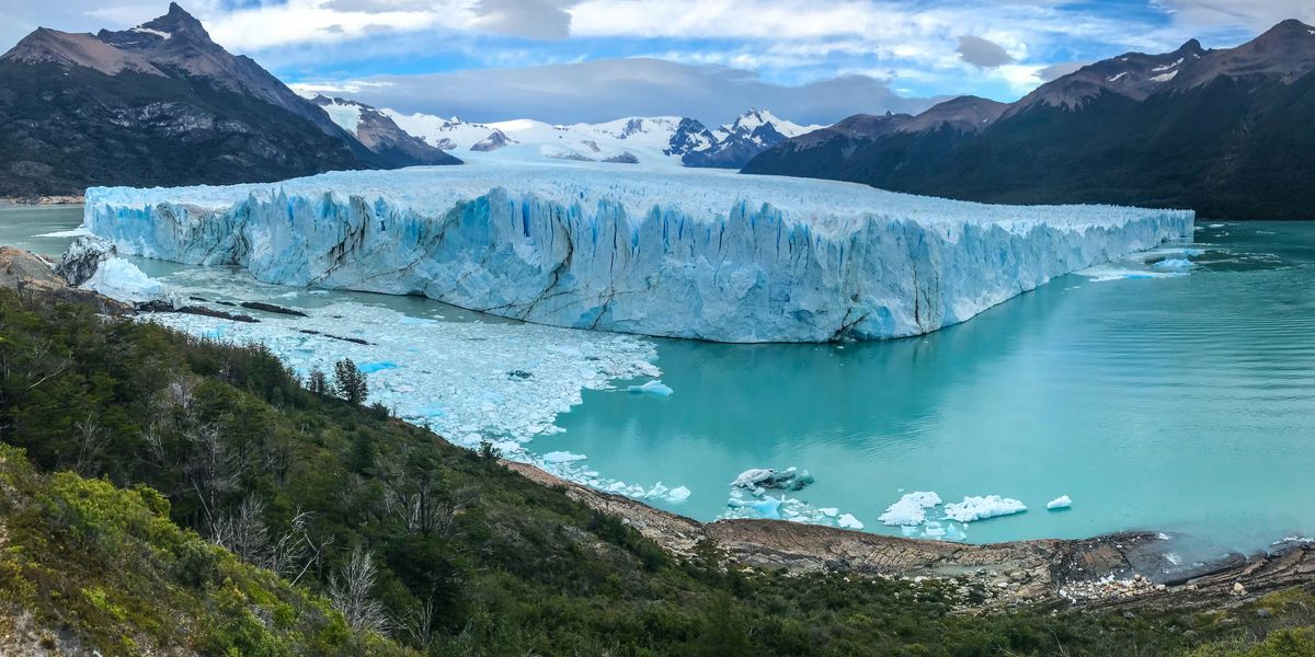 blue lake with glacier in the middle of the mountains.