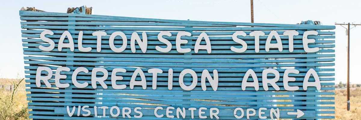 Blue sign with white letters announcing the entrance to Salton Sea Recreation Area