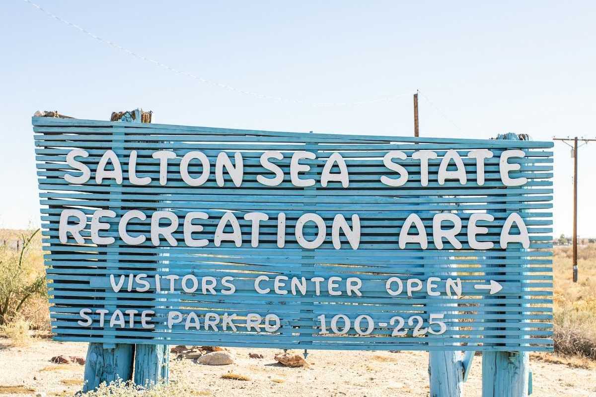Blue sign with white letters announcing the entrance to Salton Sea Recreation Area
