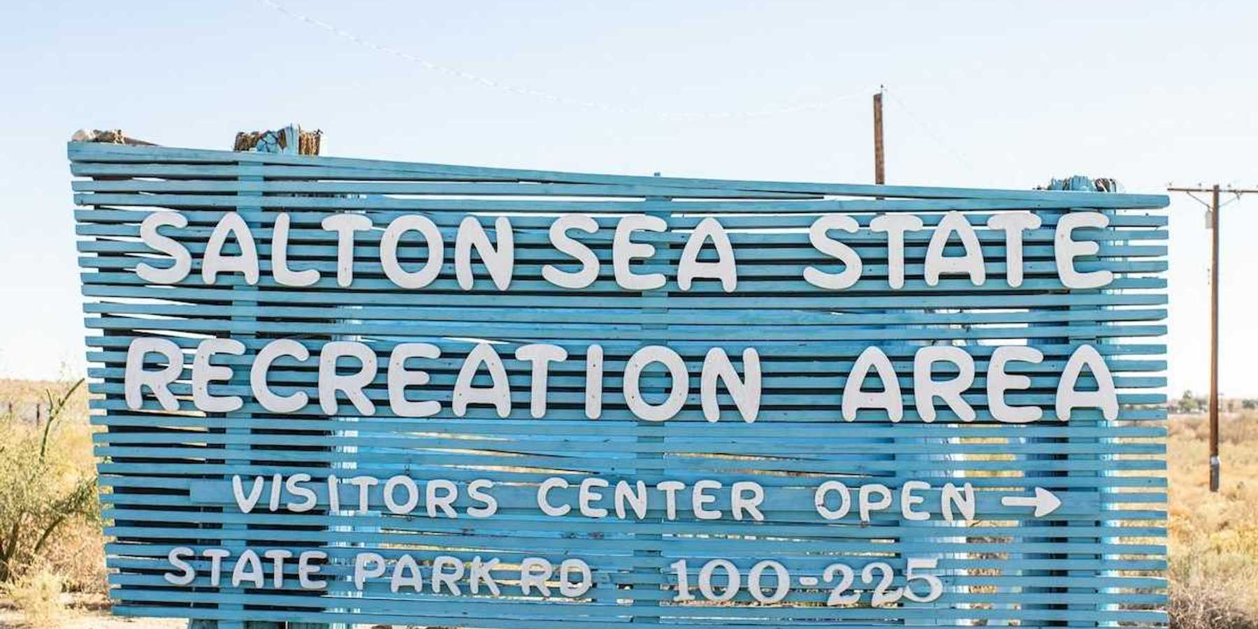 Blue sign with white letters announcing the entrance to Salton Sea Recreation Area