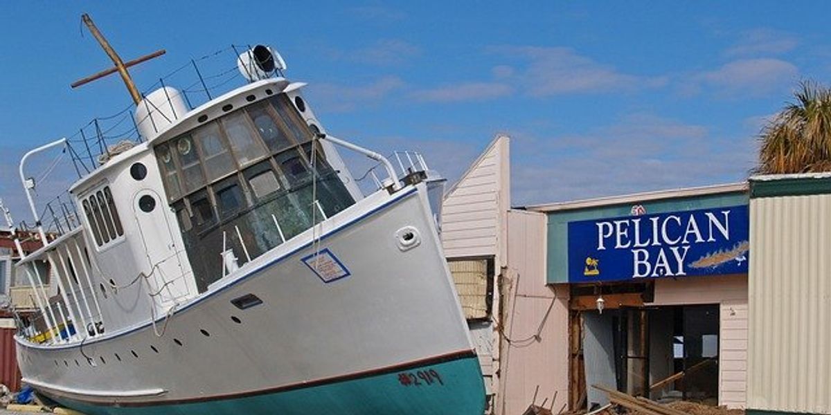 boat and a building damaged from a storm